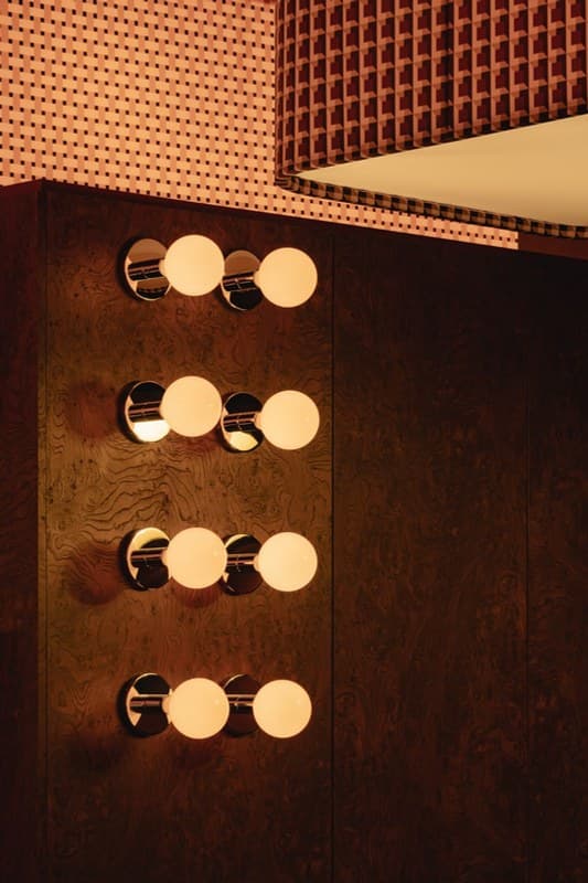 Warm vanity bulbs against walnut
